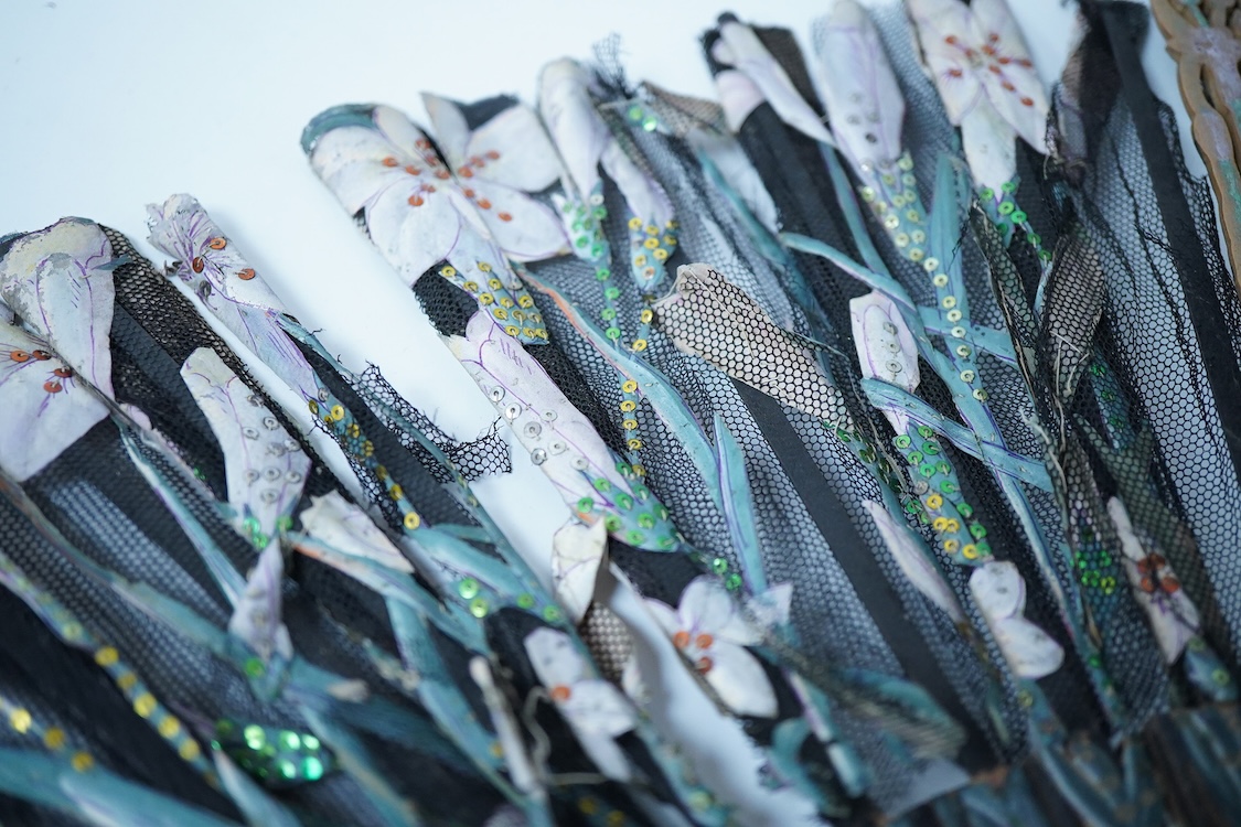 A collection of 19th century and later fans to include a black lacquered and lace example and a hand painted floral example